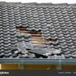 depositphotos_183883982-stock-photo-damage-caused-storm-hurricane-roof