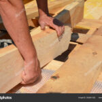 Roofing construction wooden beams, rafters, trusses with vapor barrier, insulation against leaking roof