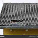 depositphotos_336559752-stock-photo-hole-roof-wind-storm