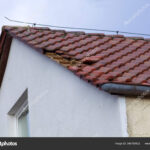 depositphotos_345758902-stock-photo-home-roof-damage-storm-fallen